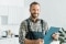 Man in overalls with a notepad