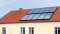 Na sliki so prikazani sončni kolektorji na strehi, ki služijo kot rezerva za ogrevanje.